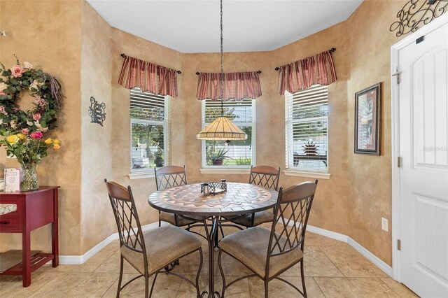 3551 Statham Dr, Apopka, FL 32712 - dining area with healthy amount of natural light, light tile patterned flooring, and baseboards
