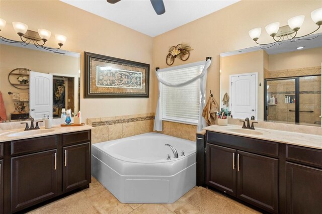 3551 Statham Dr, Apopka, FL 32712 - full bathroom with two vanities, a garden tub, a stall shower, tile patterned floors, and a ceiling fan