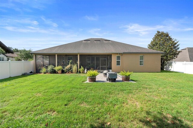 3551 Statham Dr, Apopka, FL 32712 - back of property with a sunroom, a patio area, stucco siding, and a shingled roof