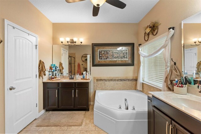 3551 Statham Dr, Apopka, FL 32712 - full bathroom featuring two vanities, a shower stall, a garden tub, ceiling fan, and tile patterned flooring
