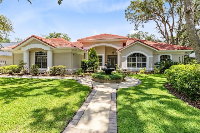 718 Glen Eagle Dr, Winter Springs, FL 32708 - mediterranean / spanish home with a tiled roof, stucco siding, and a front yard