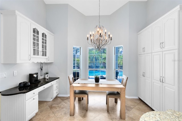 718 Glen Eagle Dr, Winter Springs, FL 32708 - dining space with a high ceiling, a chandelier, baseboards, and light tile patterned floors