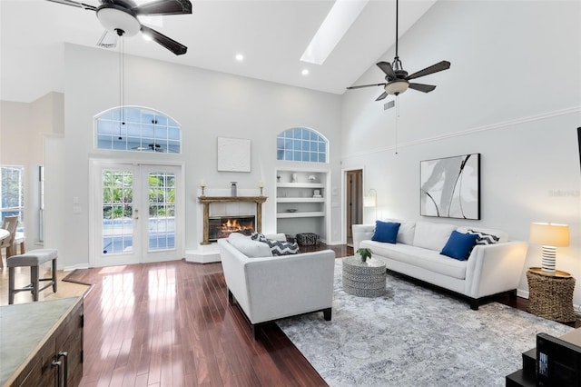 718 Glen Eagle Dr, Winter Springs, FL 32708 - living room with a ceiling fan, high vaulted ceiling, dark wood finished floors, built in features, and a skylight