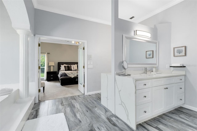 718 Glen Eagle Dr, Winter Springs, FL 32708 - ensuite bathroom with vanity, crown molding, ornate columns, baseboards, and wood finished floors