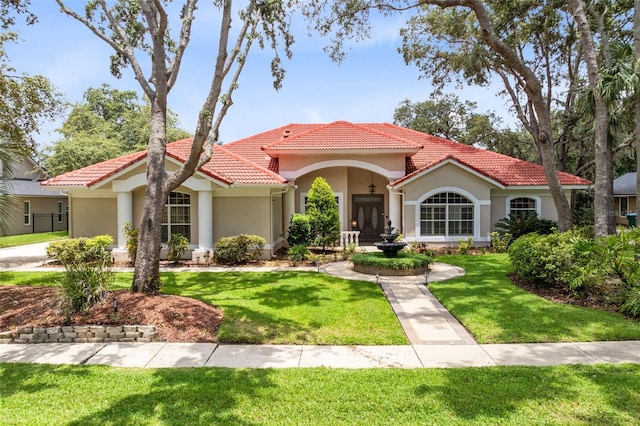 718 Glen Eagle Dr, Winter Springs, FL 32708 - mediterranean / spanish house featuring stucco siding, a tiled roof, and a front yard