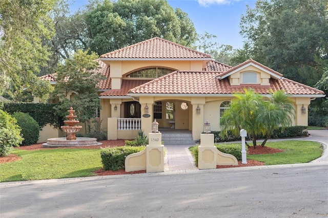 1542 Islay Ct, Apopka, FL 32712 - mediterranean / spanish house with stucco siding, covered porch, and a tiled roof