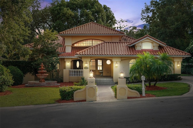 1542 Islay Ct, Apopka, FL 32712 - mediterranean / spanish-style house with stucco siding, a tile roof, and covered porch