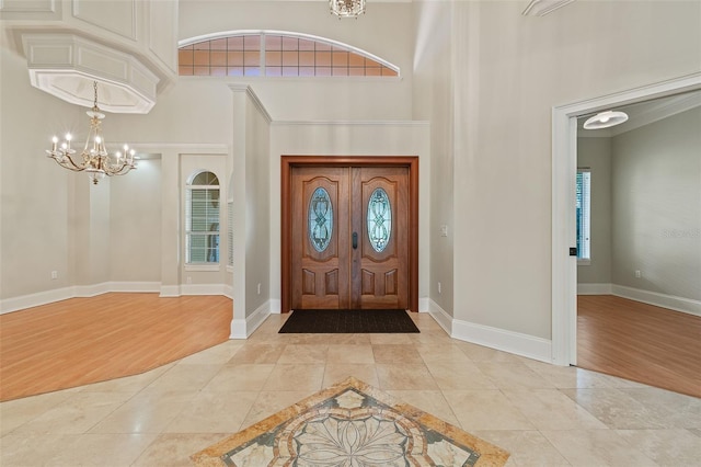 1542 Islay Ct, Apopka, FL 32712 - entrance foyer with inlaid floor details, light tile patterned flooring, a chandelier, a high ceiling, and baseboards