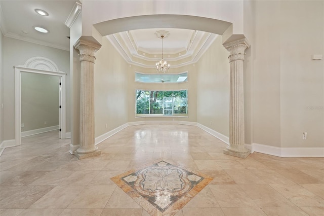 1542 Islay Ct, Apopka, FL 32712 - foyer featuring decorative columns, crown molding, arched walkways, a raised ceiling, and baseboards