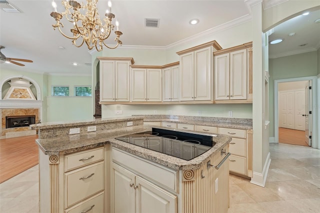 1542 Islay Ct, Apopka, FL 32712 - kitchen with black electric cooktop, cream cabinetry, open floor plan, recessed lighting, and ornamental molding