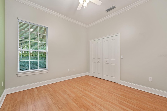 1542 Islay Ct, Apopka, FL 32712 - unfurnished bedroom with multiple windows, crown molding, light wood-type flooring, baseboards, and a closet