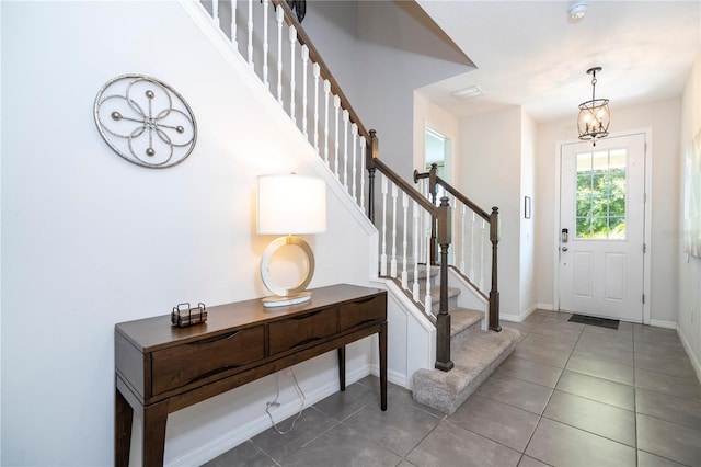 1505 Nassau Point Trl, Kissimmee, FL 34747 - entrance foyer with tile patterned flooring, stairs, and baseboards