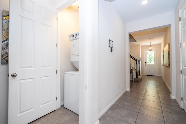 1505 Nassau Point Trl, Kissimmee, FL 34747 - hall with estacked washer and dryer, tile patterned flooring, stairway, baseboards, and recessed lighting