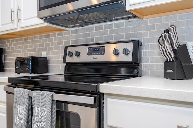 1505 Nassau Point Trl, Kissimmee, FL 34747 - kitchen featuring appliances with stainless steel finishes, tasteful backsplash, white cabinets, and light stone countertops