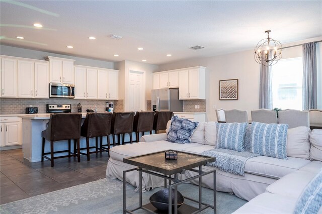 1505 Nassau Point Trl, Kissimmee, FL 34747 - living area with recessed lighting, a chandelier, and dark tile patterned flooring