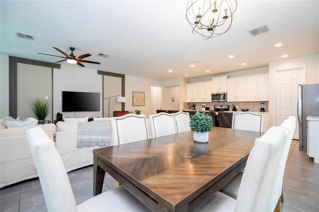1505 Nassau Point Trl, Kissimmee, FL 34747 - dining space with light tile patterned floors, recessed lighting, a chandelier, and ceiling fan