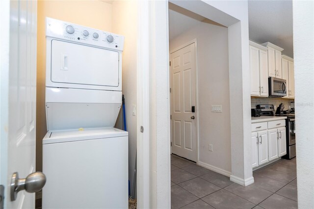 1505 Nassau Point Trl, Kissimmee, FL 34747 - laundry area with estacked washer and dryer and tile patterned floors