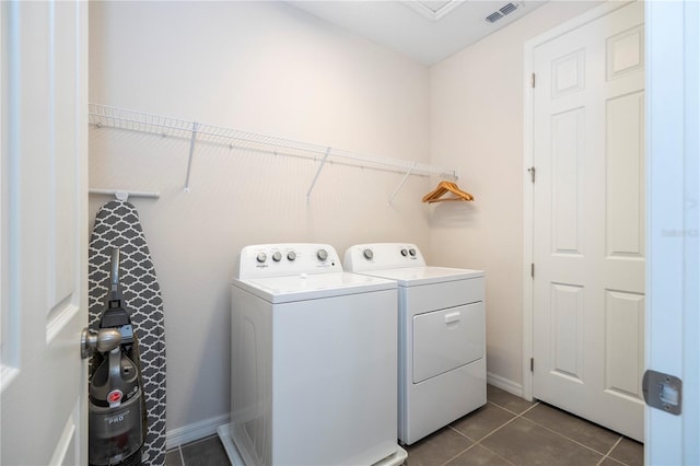 1505 Nassau Point Trl, Kissimmee, FL 34747 - washroom with independent washer and dryer, dark tile patterned flooring, and baseboards