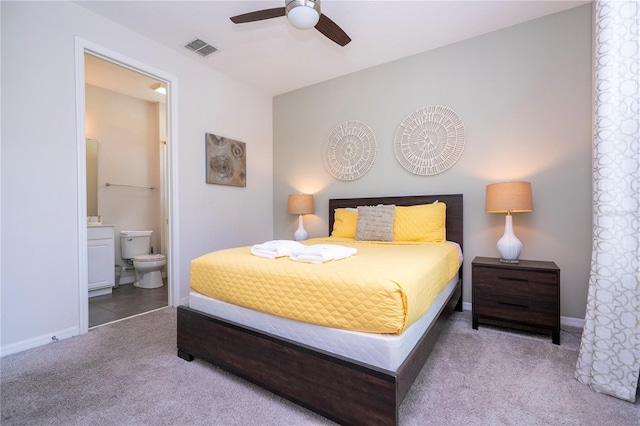 1505 Nassau Point Trl, Kissimmee, FL 34747 - bedroom with carpet flooring, ensuite bathroom, baseboards, and ceiling fan