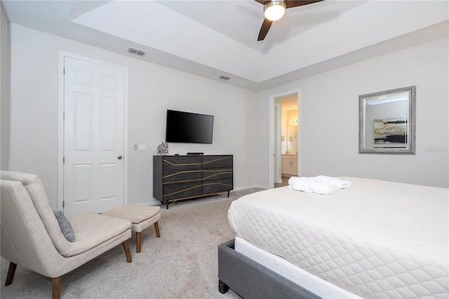1505 Nassau Point Trl, Kissimmee, FL 34747 - bedroom with light colored carpet, a tray ceiling, and a ceiling fan