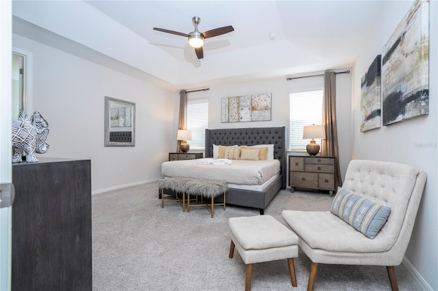 1505 Nassau Point Trl, Kissimmee, FL 34747 - bedroom featuring multiple windows, carpet flooring, a tray ceiling, and ceiling fan