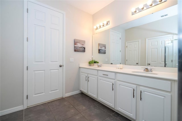 1505 Nassau Point Trl, Kissimmee, FL 34747 - bathroom featuring double vanity, tile patterned flooring, and baseboards