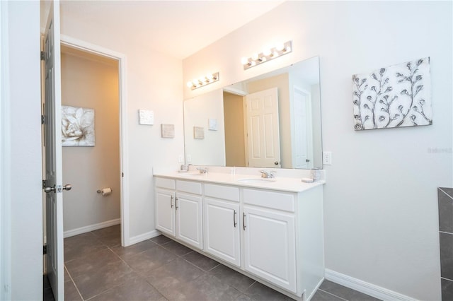 1505 Nassau Point Trl, Kissimmee, FL 34747 - bathroom with double vanity, baseboards, and tile patterned floors
