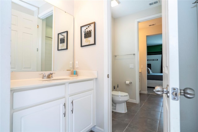 1505 Nassau Point Trl, Kissimmee, FL 34747 - bathroom featuring vanity, tile patterned flooring, toilet, ensuite bath, and baseboards