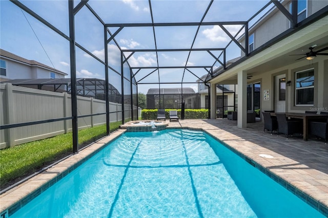1505 Nassau Point Trl, Kissimmee, FL 34747 - view of swimming pool with ceiling fan, a patio, a pool with connected hot tub, and a lanai