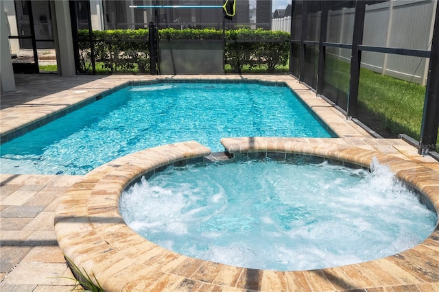 1505 Nassau Point Trl, Kissimmee, FL 34747 - view of swimming pool featuring a pool with connected hot tub and a lanai