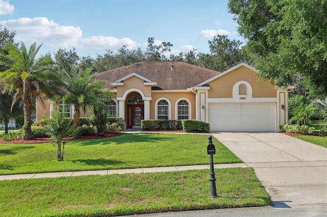 604 Cheviot Ct, Apopka, FL 32712 - mediterranean / spanish home with a garage, a front yard, concrete driveway, and stucco siding