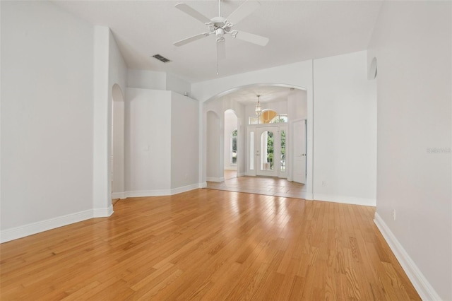604 Cheviot Ct, Apopka, FL 32712 - unfurnished room featuring arched walkways, light wood finished floors, a ceiling fan, and baseboards