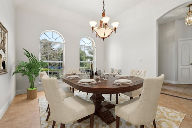 604 Cheviot Ct, Apopka, FL 32712 - dining space with a chandelier, arched walkways, light tile patterned flooring, and baseboards