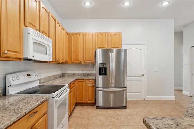 604 Cheviot Ct, Apopka, FL 32712 - kitchen featuring white appliances, light stone countertops, backsplash, light tile patterned floors, and recessed lighting
