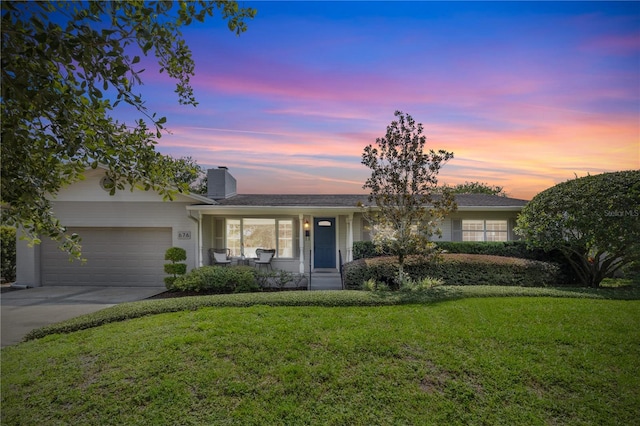 676 Dunblane Dr, Winter Park, FL 32792 - view of front of property with a front lawn, covered porch, a garage, driveway, and a chimney