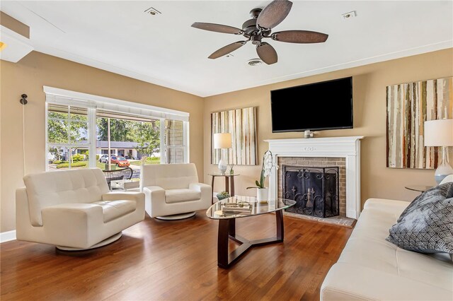 676 Dunblane Dr, Winter Park, FL 32792 - living area featuring ceiling fan, wood finished floors, a brick fireplace, and baseboards