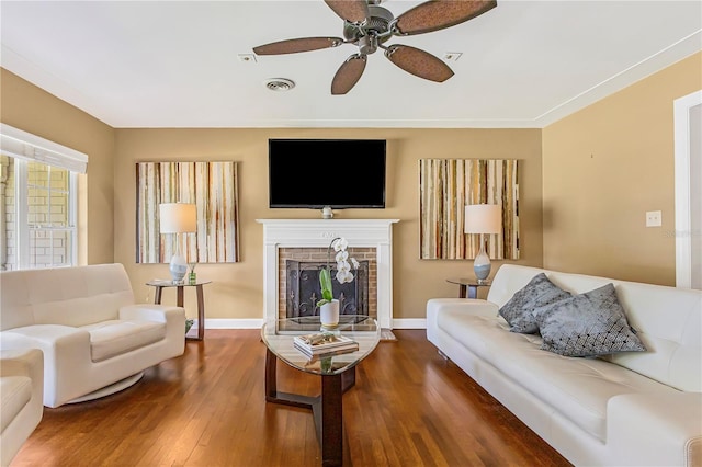 676 Dunblane Dr, Winter Park, FL 32792 - living area featuring wood finished floors, a brick fireplace, baseboards, and a ceiling fan