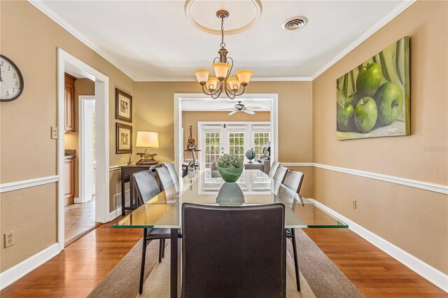 676 Dunblane Dr, Winter Park, FL 32792 - dining area featuring a chandelier, wood finished floors, ornamental molding, and baseboards
