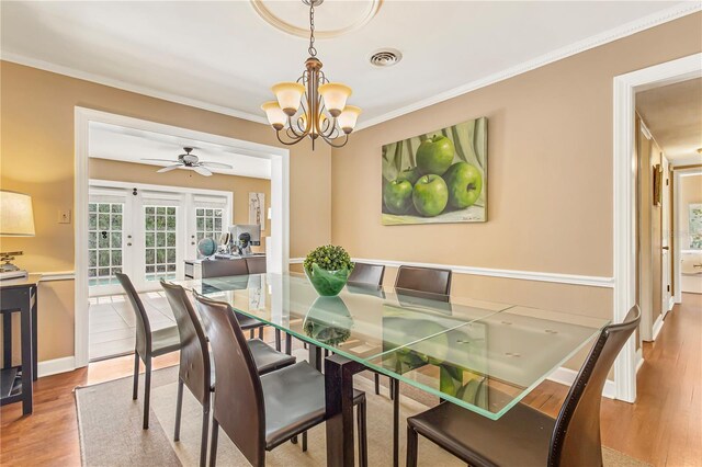 676 Dunblane Dr, Winter Park, FL 32792 - dining area with a chandelier, wood finished floors, crown molding, and ceiling fan