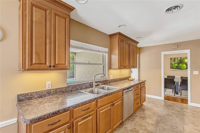 676 Dunblane Dr, Winter Park, FL 32792 - kitchen with dishwasher, a sink, dark countertops, brown cabinets, and baseboards