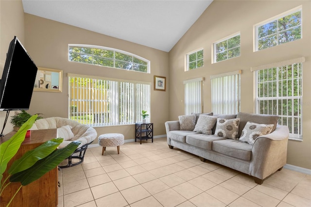 8507 Crystal Cove Loop, Kissimmee, FL 34747 - living area with baseboards, light tile patterned floors, and high vaulted ceiling