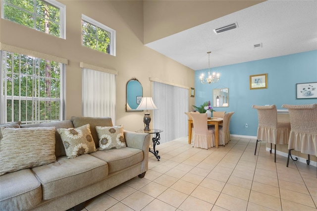 8507 Crystal Cove Loop, Kissimmee, FL 34747 - living room featuring a chandelier, light tile patterned floors, and a towering ceiling