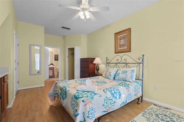 8507 Crystal Cove Loop, Kissimmee, FL 34747 - bedroom with light wood-type flooring, baseboards, connected bathroom, and a ceiling fan