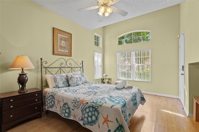 8507 Crystal Cove Loop, Kissimmee, FL 34747 - bedroom with wood finished floors, a textured ceiling, baseboards, and ceiling fan