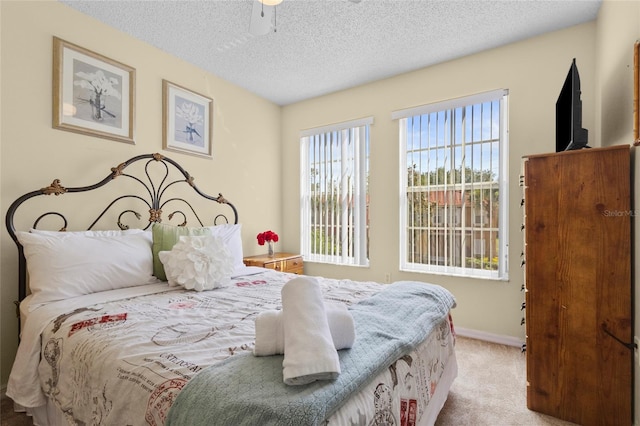 8507 Crystal Cove Loop, Kissimmee, FL 34747 - carpeted bedroom with a textured ceiling, baseboards, and a ceiling fan