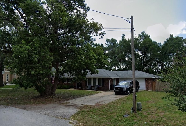 1511 Hobson St, Longwood, FL 32750 - single story home with driveway, an attached garage, and brick siding