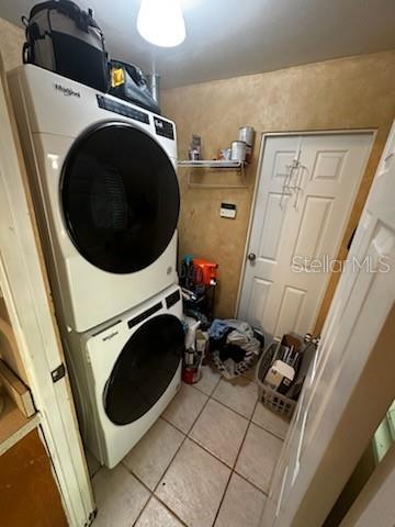 1511 Hobson St, Longwood, FL 32750 - laundry area with stacked washer / dryer and light tile patterned floors