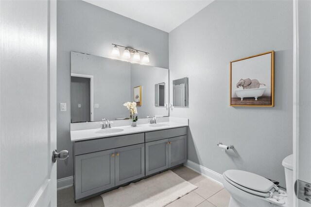 13227 Spring Grove Way, Winter Garden, FL 34787 - bathroom featuring double vanity, tile patterned flooring, toilet, and baseboards