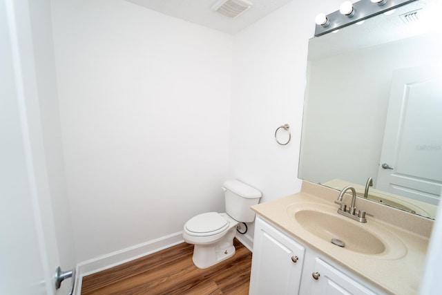 12106 Poppy Field Ln Unit 107, Orlando, FL 32837 - half bath featuring wood finished floors, vanity, toilet, and baseboards
