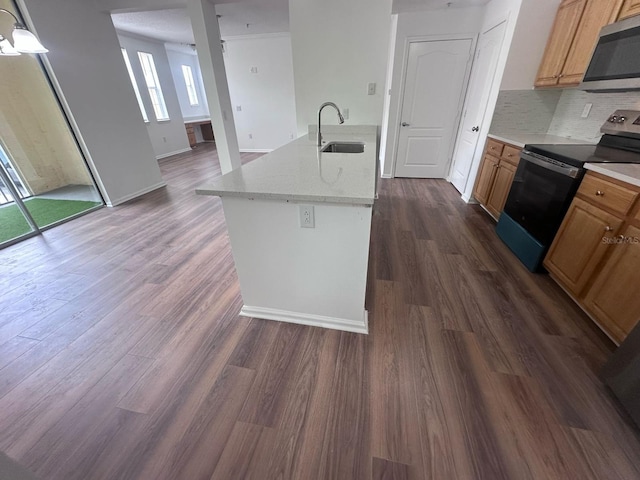 12106 Poppy Field Ln Unit 107, Orlando, FL 32837 - kitchen featuring appliances with stainless steel finishes, a sink, tasteful backsplash, dark wood-type flooring, and brown cabinets